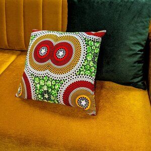 New colorful african print accent pillow a pattern of gold, orange, green.